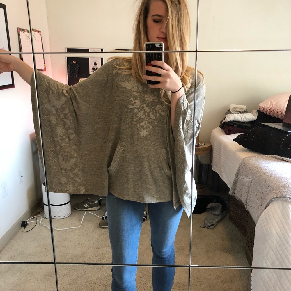 Poncho with white stitching detail.